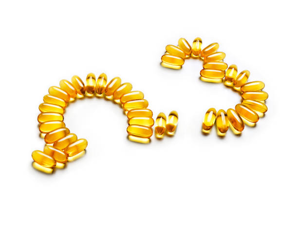 istock Omega 3 capsules forming symbols isolated on white background 653347804