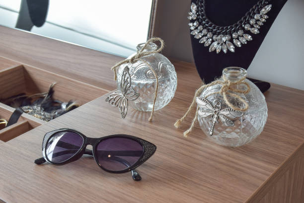 istock Sunglasses crystal jars and necklace on dressing table 653347914