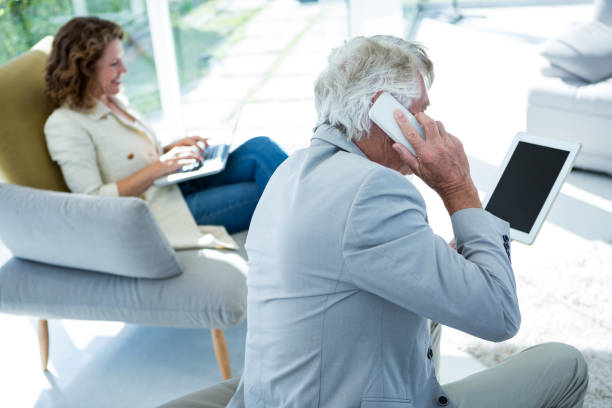 istock Man by woman talking on cellphone 653348512