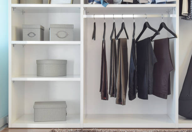 istock modern closet with row of pants hanging in white wardrobe 653348622