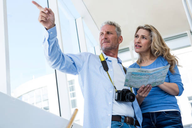 istock Front view of mature couple holding map 653349462