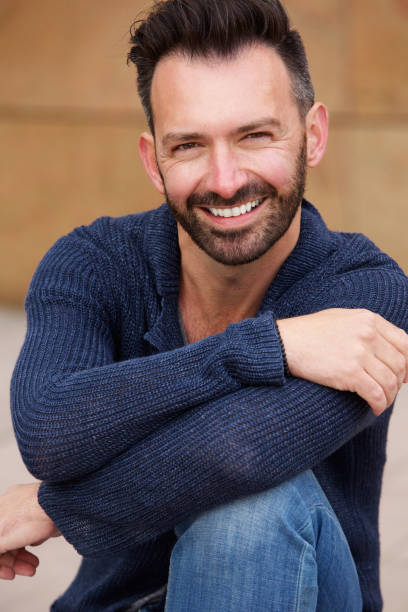 istock Smart mature man sitting outdoors and smiling 653352868