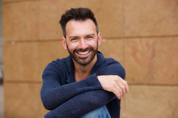istock Cheerful middle aged man sitting outdoor 653355096