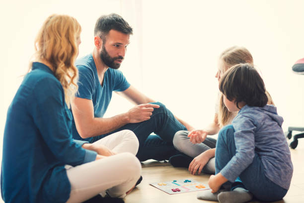 istock Family Playing Board Game At Home 653358326