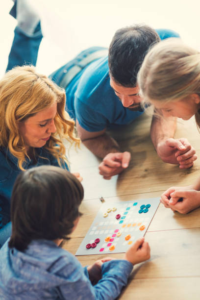 Family Playing Board Game At Home stock photo