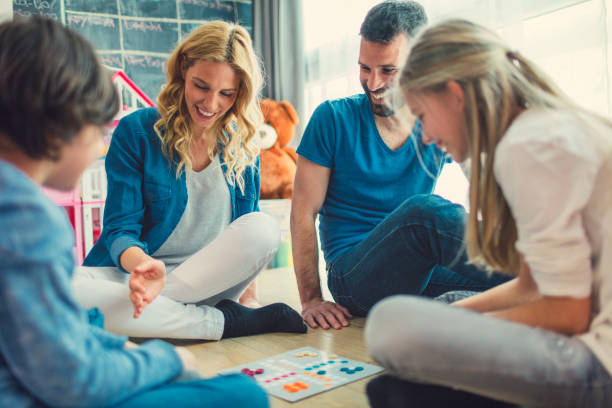istock Family Playing Board Game At Home 653360782