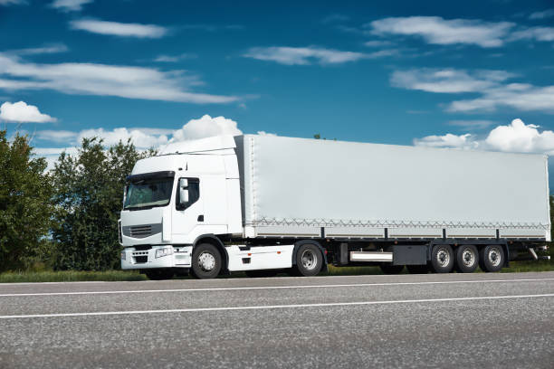 istock White truck on road with blue sky, cargo transportation concept 653360798