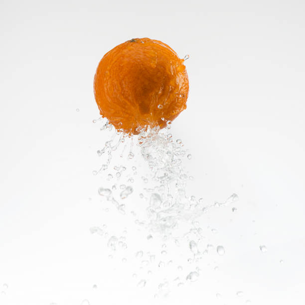 orange in water splash on white background