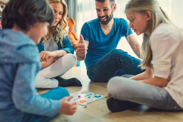 istock Family Playing Board Game At Home 653361098