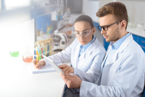 istock portrait of concentrated scientists using digital tablet during work in laboratory 653361136