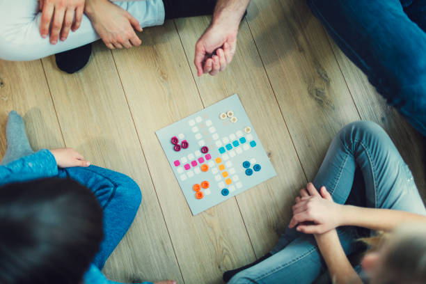 istock Family Playing Board Game At Home 653361146