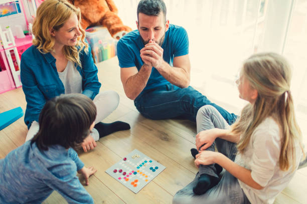 istock Family Playing Board Game At Home 653361152