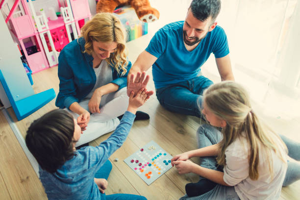 istock Family Playing Board Game At Home 653361788