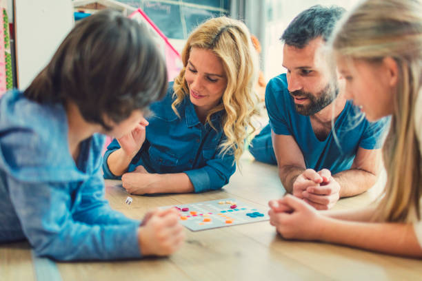 istock Family Playing Board Game At Home 653361928