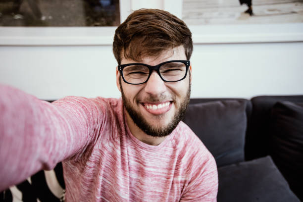 istock Hipster with sticking his tongue out taking selife 653364254