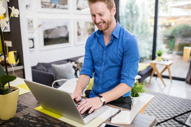 istock Handsome redhead man chatting online on laptop. 653365054