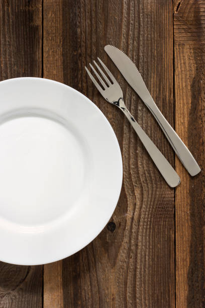 istock Empty Plate And Cutlery On The Wooden Table 653367680