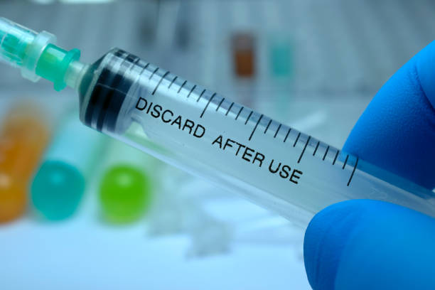 istock Syringe, medical injection in hand, palm or fingers. 653371354