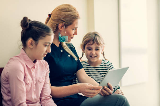 istock Girls at dentist office 653371356