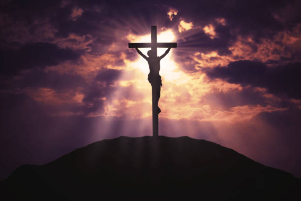 Christian cross on hill at sunrise Picture of a christian cross on the hill with sunbeam on the sky at sunrise time religious cross stock pictures, royalty-free photos & images
