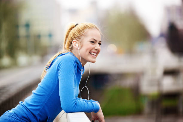 istock Blonde woman is having break after jogging 653375282