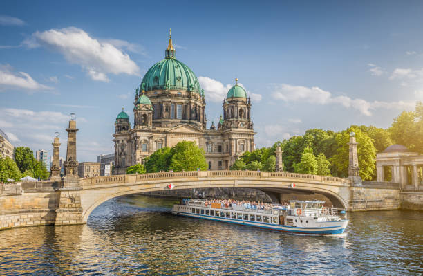 istock Berlin Cathedral with ship on Spree river at sunset, Berlin, Germany 653375768
