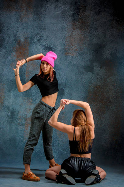 istock The two attractive girls dancing twerk in the studio 653378994
