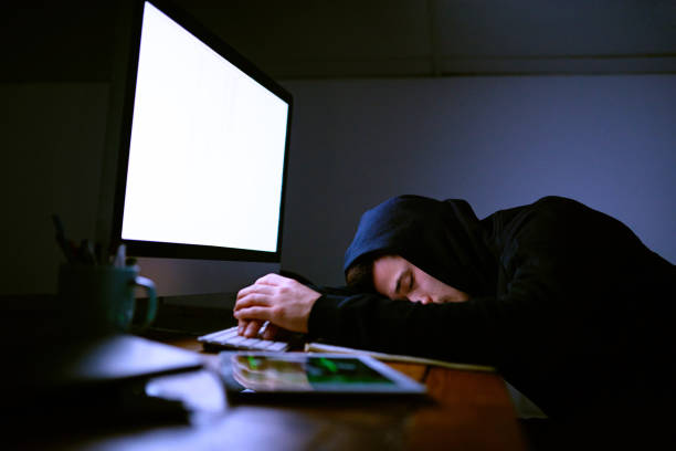 istock Falling asleep by the light of his monitor 653379018