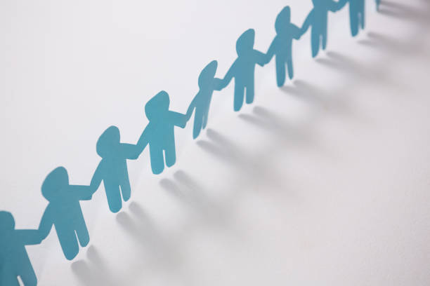 istock Row of blue paper cut-out figures 653386468