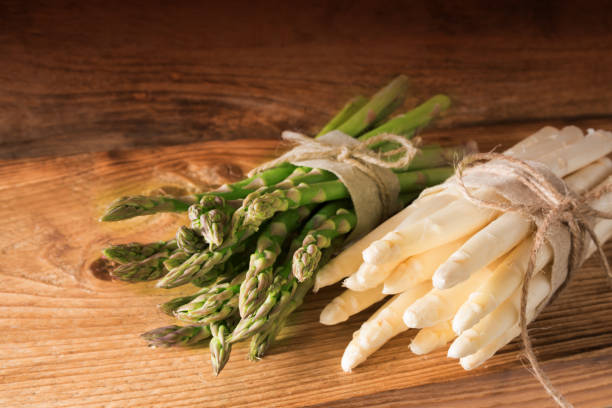 istock Bound asparagus on a wooden board 653387916