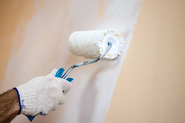 istock Close up view of man's hand holding paint roller 653391308