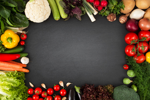 Fresh vegetables on blackboard with copy space.