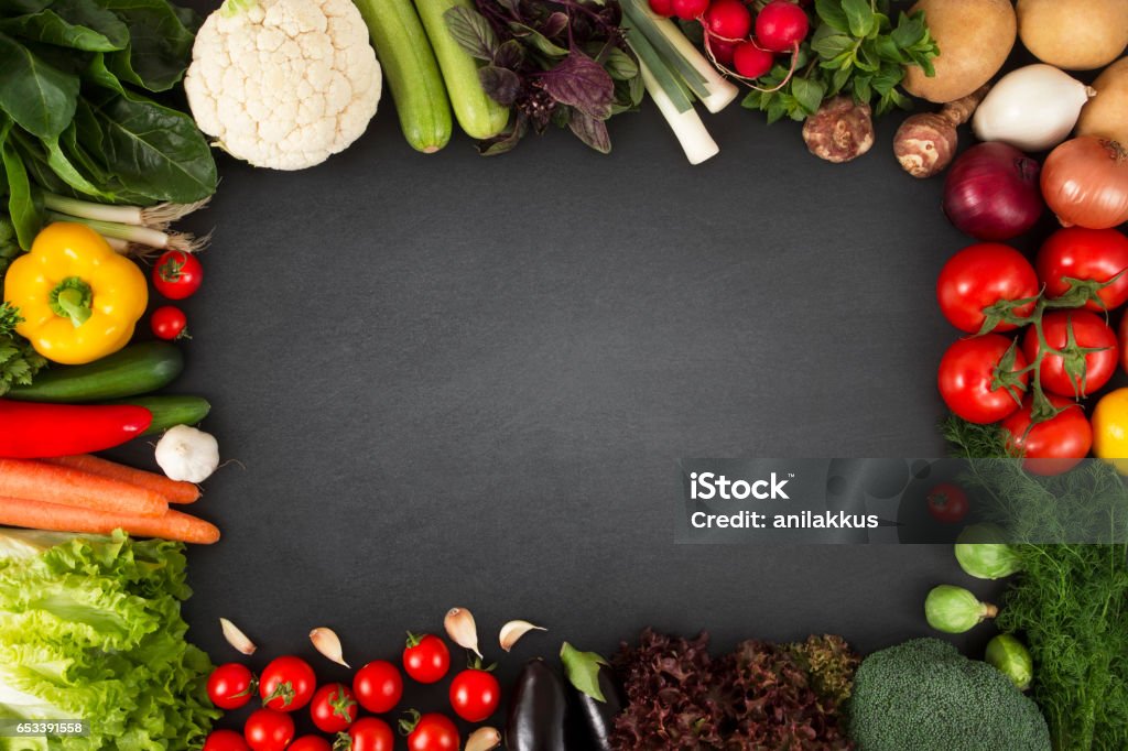 Fresh Organic Vegetables on Blackboard Fresh vegetables on blackboard with copy space. Vegetable Stock Photo