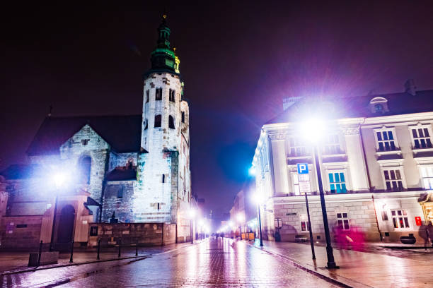Night street in the Krakow, Poland. Colorful night illumination reflecting in the wet stone pavement of the old town. Beautiful background photo.