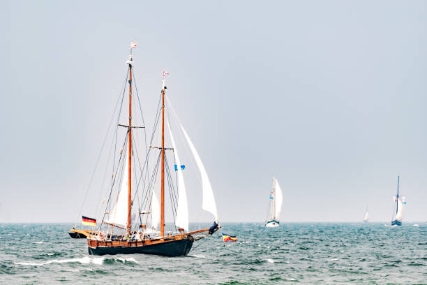A tiny but brave sailing  boat starting his journey into the open waters of the Mediterranean sea