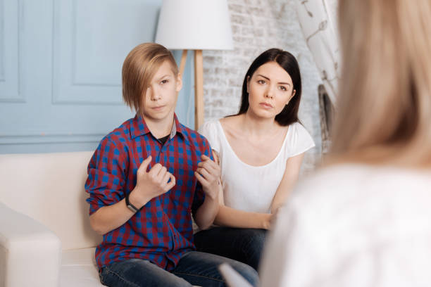 istock Mother and son sitting on consultation 653401250