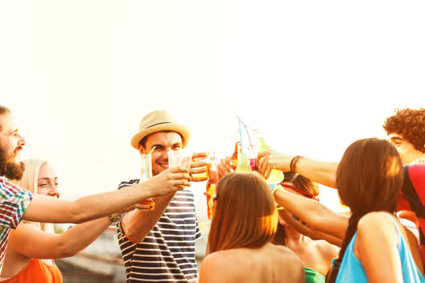 istock Friends toasting drinks at a party 653401568