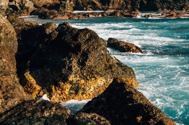 istock Rocky coastline and turquoise colored ocean waves in sunlight 653401858