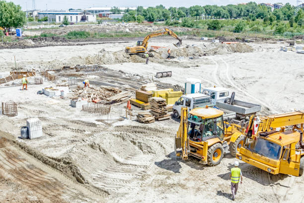istock Crane, trucks are parked at building site 653408920