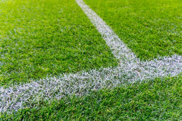 istock White stripe on the green soccer field from top view 653410080