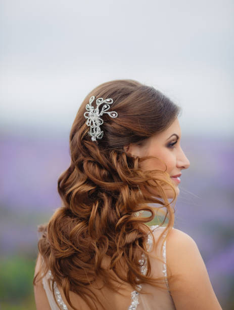 istock Bride in wedding dress in a blooming lavender field 653416466