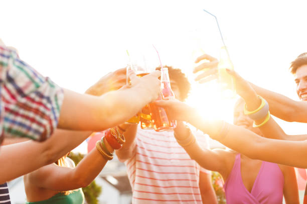 istock Friends toasting at rooftop party 653423398