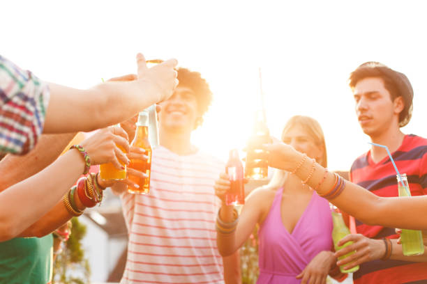 istock Friends toasting at rooftop party 653423418
