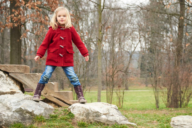 istock A cute five year old blond girl posing on a rock outside 653423608