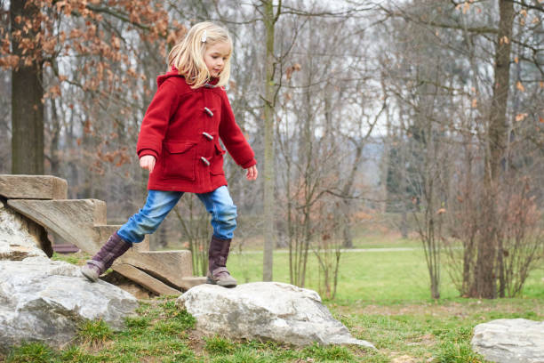 istock A cute five year old blond girl posing on a rock outside 653423638