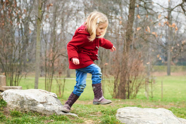istock A cute five year old blond girl posing on a rock outside 653423654