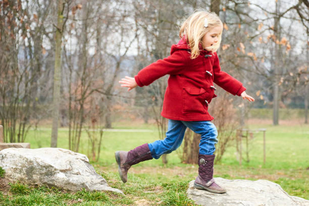 istock A cute five year old blond girl posing on a rock outside 653423726