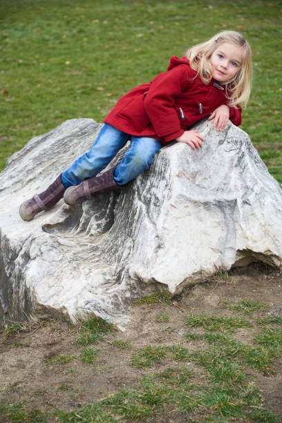 istock A cute five year old blond girl posing on a rock outside 653423866