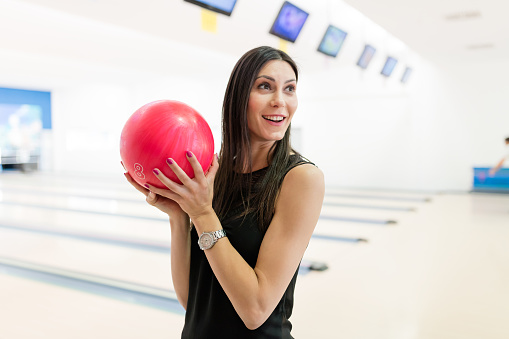 Beautiful female getting ready to throw the bowling ball