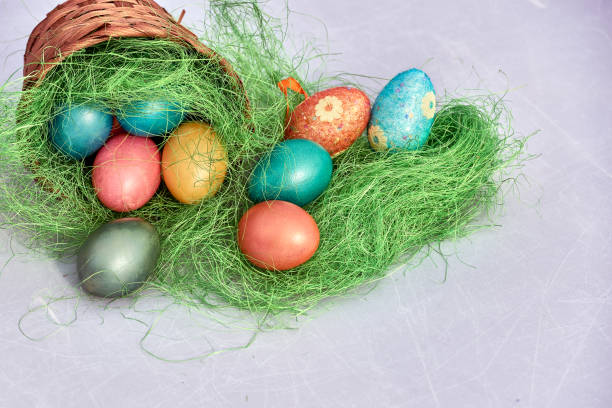 istock Easter basket filled with colorful eggs on a white background 653429568